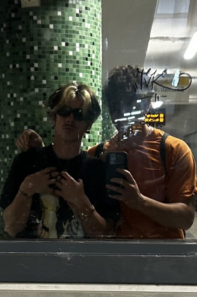 Josh and Leo pose in front of a Mirror